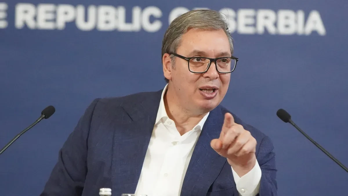 Aleksandar Vučić govori za govornicom ispred plavog panoa