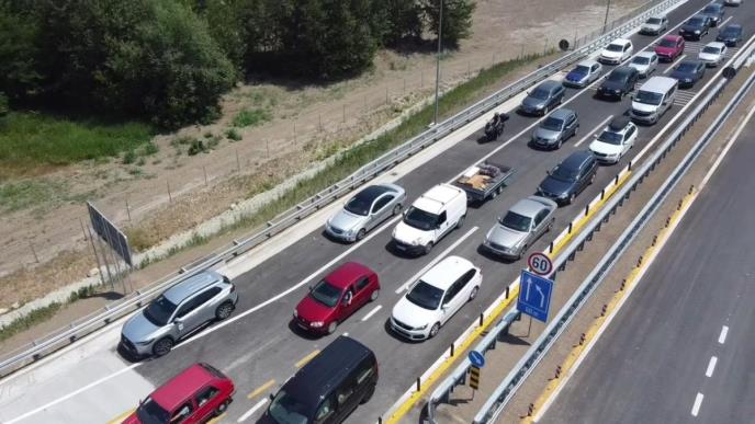 Vazdušni snimak gustog saobraćaja u dve trake na auto-putu, kolone automobila između zaštitnih ograda