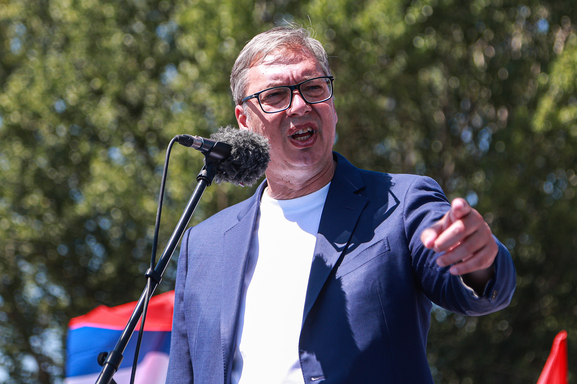 Aleksandar Vučić govori za mikrofonom i pokazuje rukom ka publici