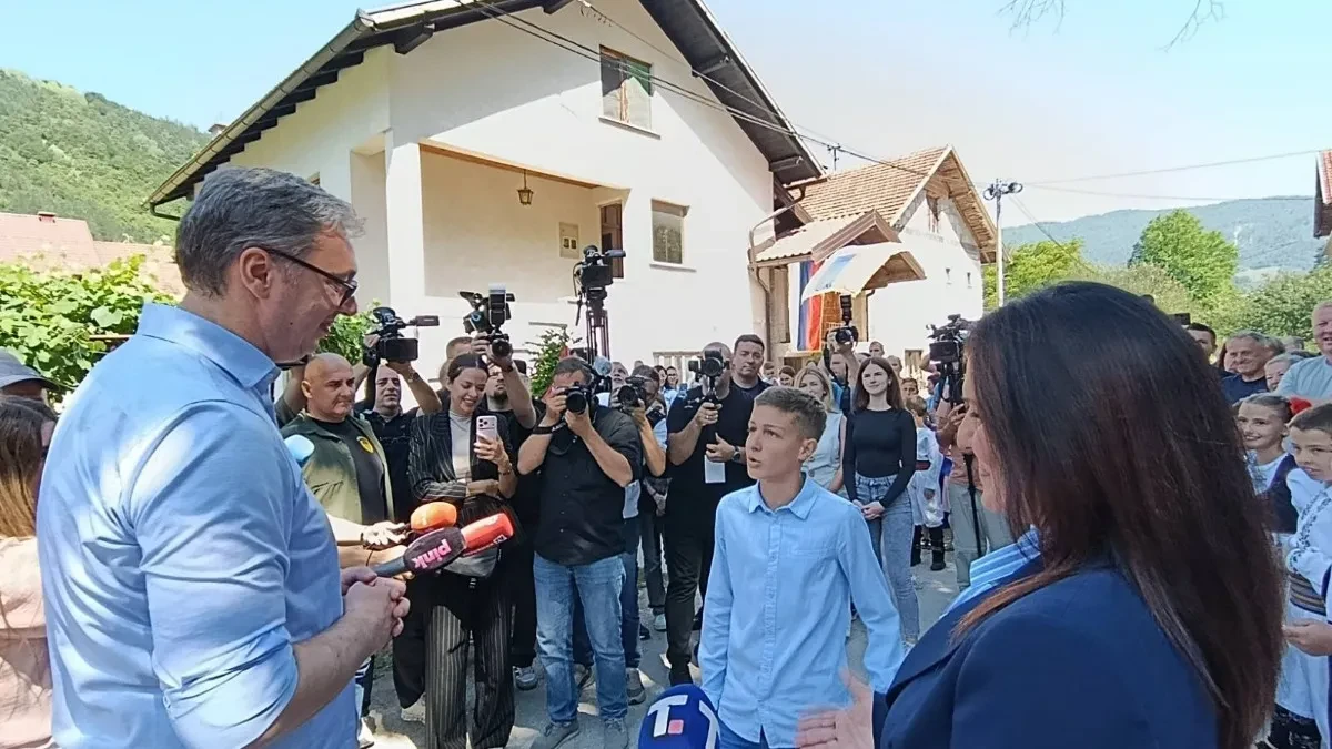 Aleksandar Vučić razgovara sa dečakom ispred kuće, okružen novinarima i meštanima