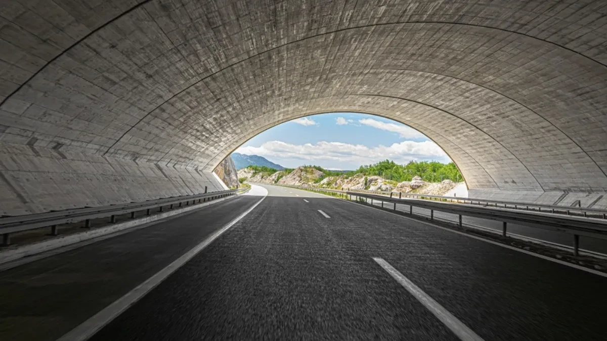 Autoput u tunelu sa izlazom na planinski predeo (ilustracija)